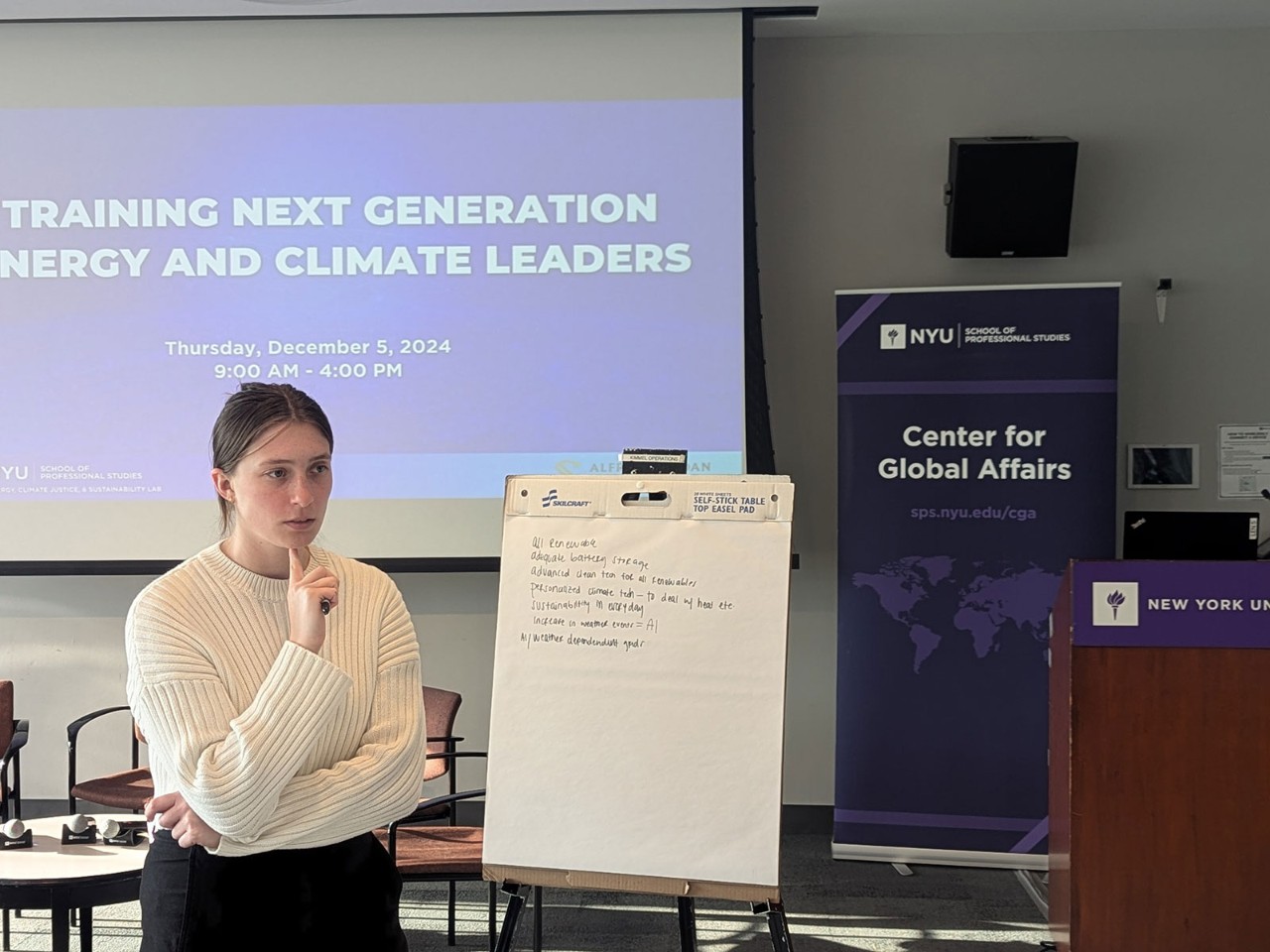 Student in front of white board and screen saying "Training Next Generation Energy and Climate Leaders"