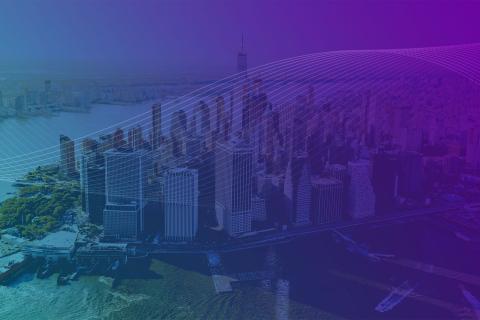 Aerial view of a city skyline with a purple and blue gradient overlay and white curved lines across the image.