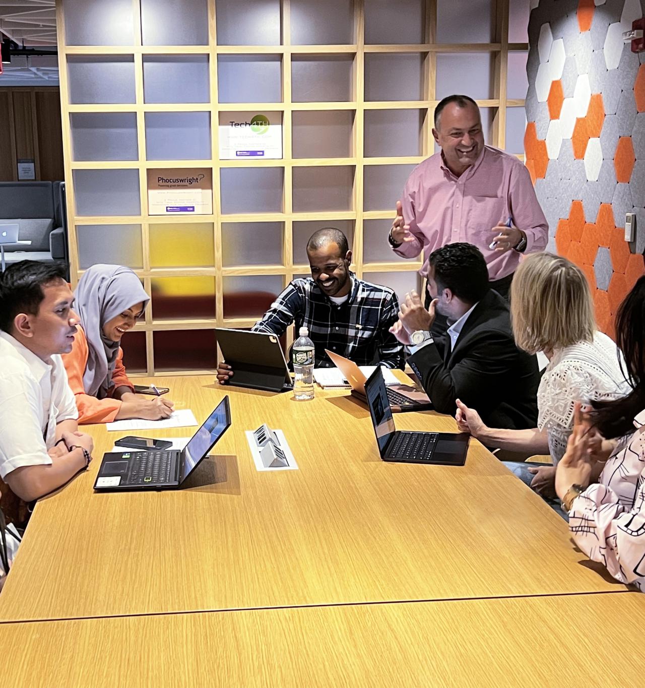 Students discuss their cohort presentations with their instructor