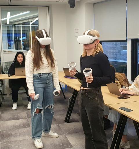Two students wear VR headsets.