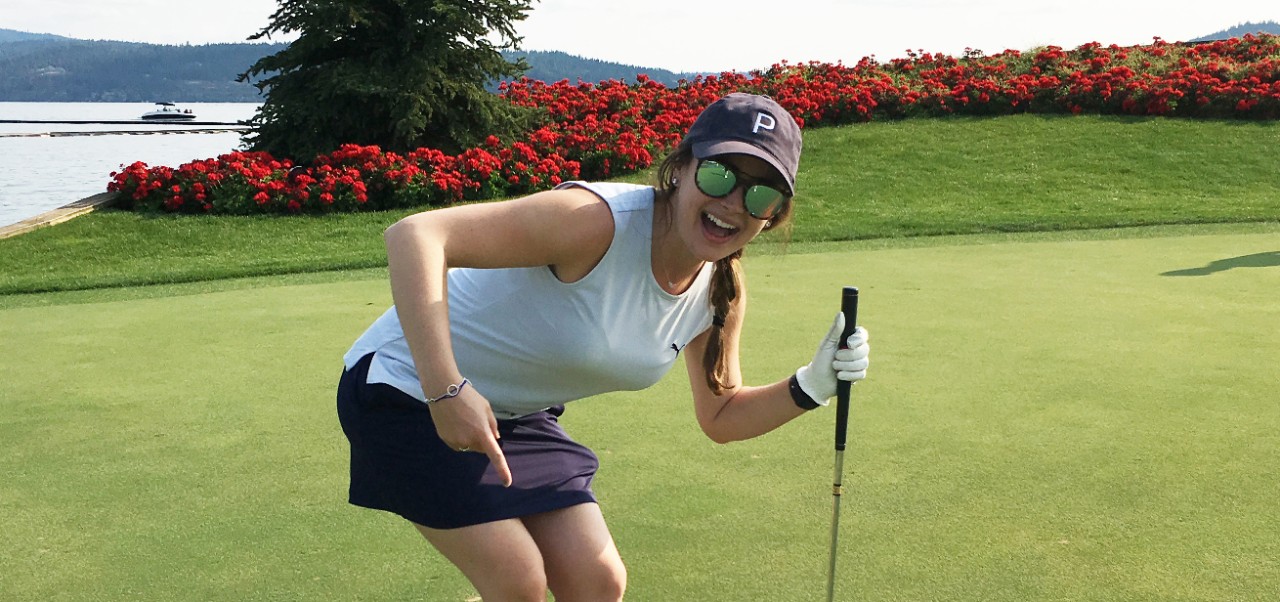 Alexa Strobridge, Tisch Center for Global Sport alumnus at NYU SPS, poses for a photo while playing golf.