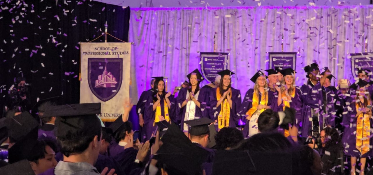 Samantha O'Connell, Center for Publishing and Applied Liberal Arts at NYU SPS alumnus, celebrates graduation alongside classmates on stage while confetti falls aroun them.