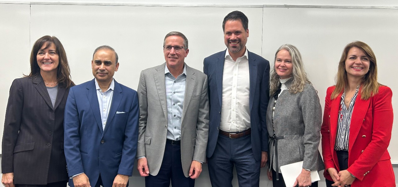 Kathleen Rennie, Clinical Assistant Professor of Marketing and Public Relations, Division of Programs in Business at NYU SPS, poses for a photo with colleagues.