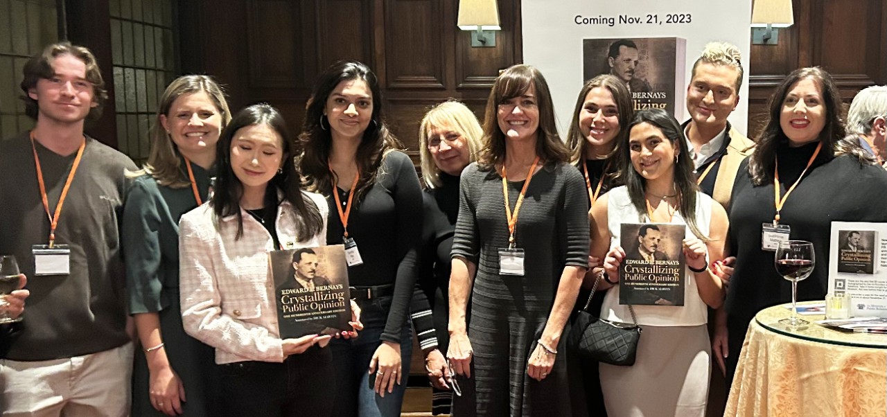 Kathleen Rennie, Clinical Assistant Professor of Marketing and Public Relations, Division of Programs in Business at NYU SPS, poses for a photo with colleagues