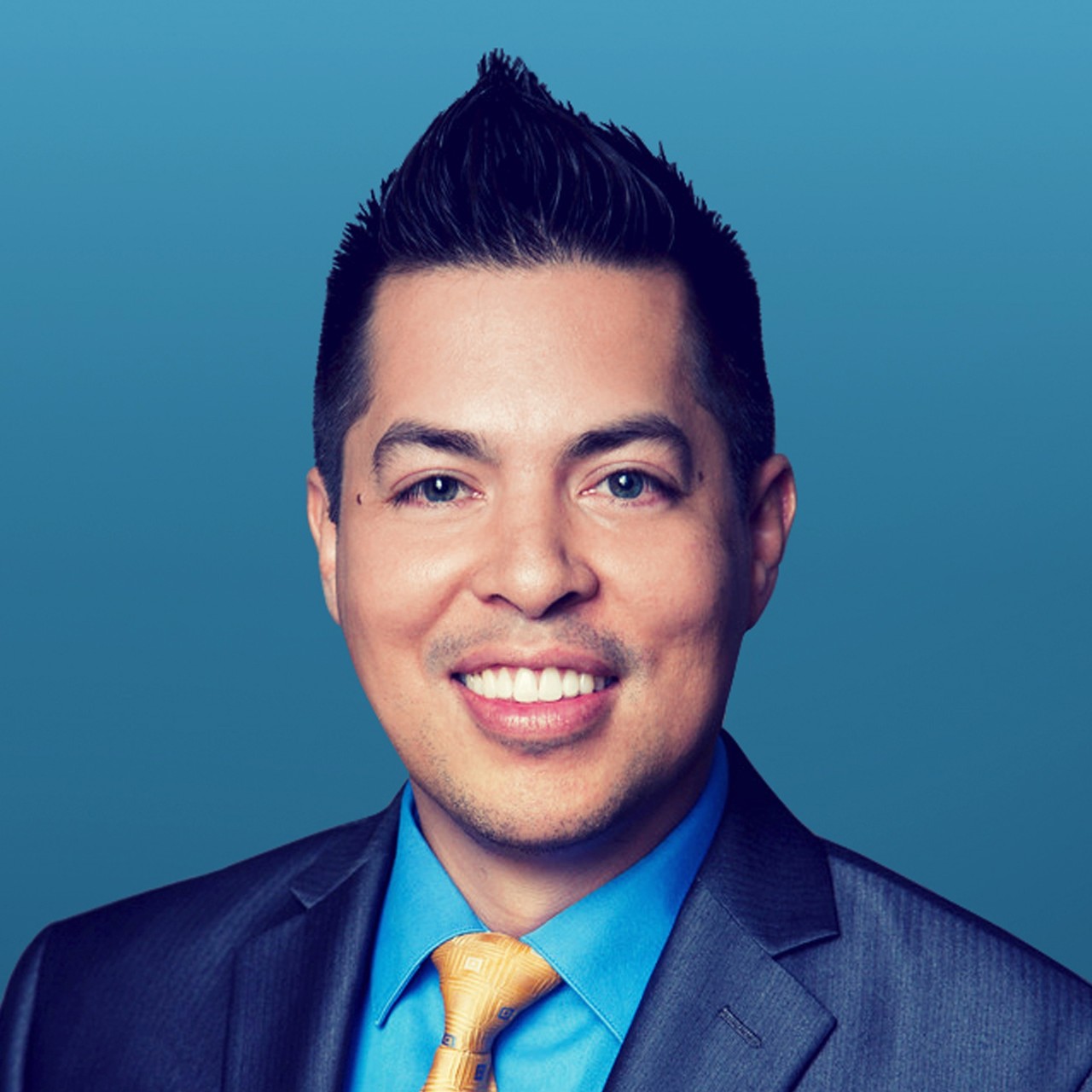 Headshot of Raul Sanchez smiling wearing a suit and tie.