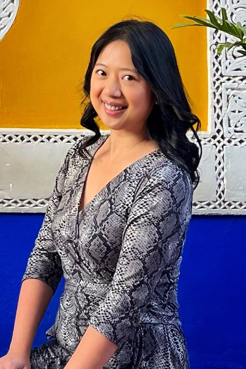 Porsha Seechung, student at the Division of Programs in Business at NYU SPS, smiles for a camera at a castle in the Scottish Highlands.