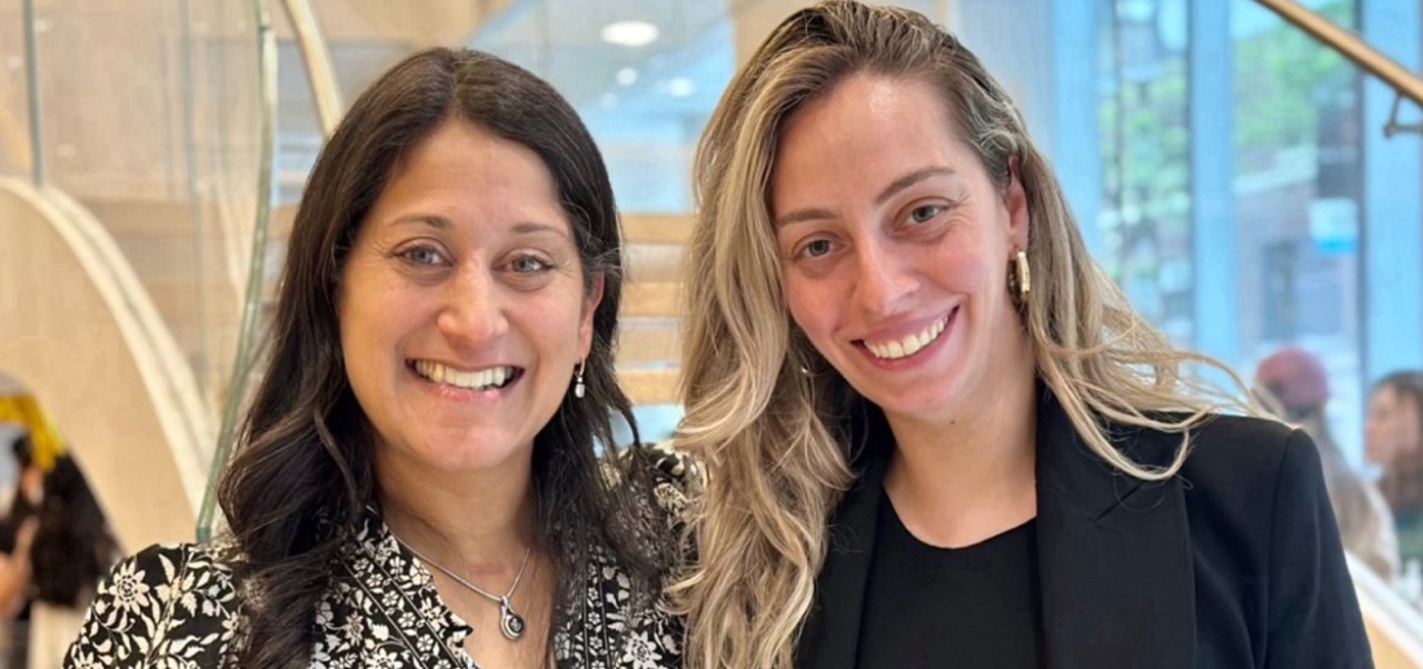 Siri Kostanyan, Division of Business Programs student at NYU SPS, poses for a photo with a colleague at a reception.