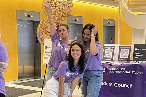 Students stand in front of booth.