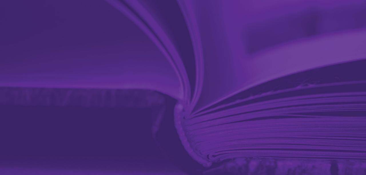 An open Dell laptop with the message "Get Published!" over a purple background. To the left a potted plant and pair of glasses, to the right a cell phone and another plant.