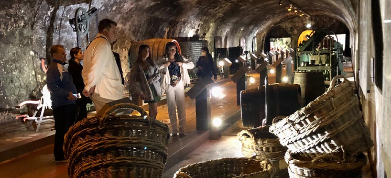 NYU SPS students peruse handmade wicker baskets at a bazaar while participating in a Global Field Intensive.