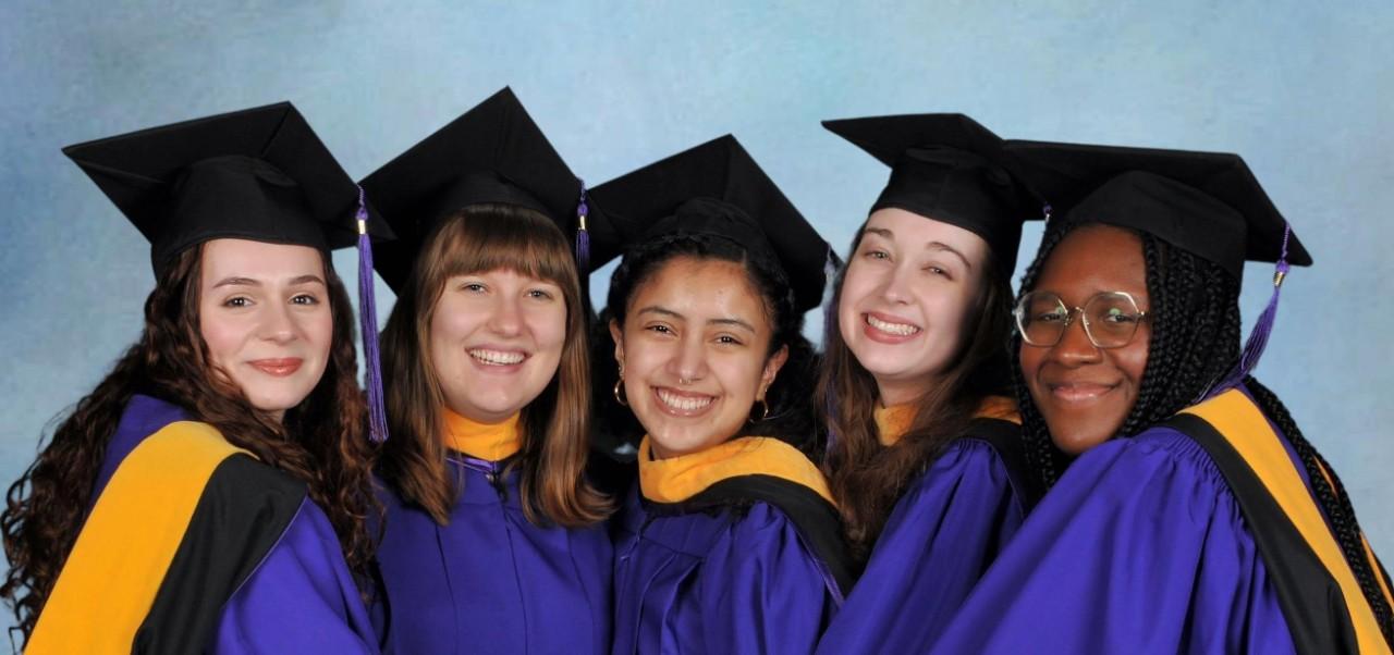 Abigail Jordan, Center for Publishing and Liberal Arts at NYU SPS alumnus, poses for a photo with four friends, all dressed in cap and gown, on graduation day.