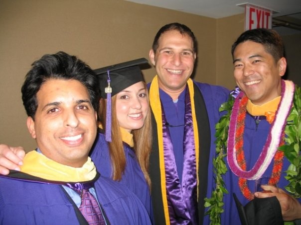 Adjunct instructor Toni Haught poses with fellow grads wearing graduation gowns.