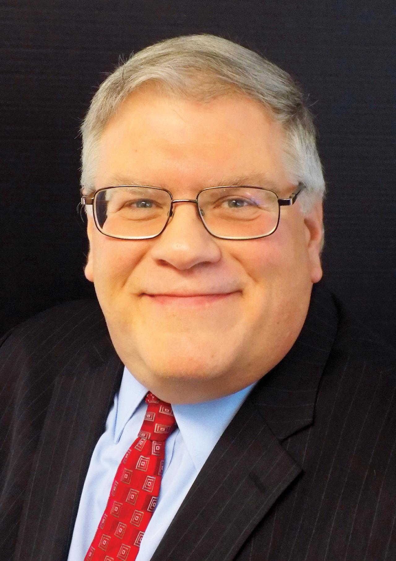 NYU SPS Continuing Education instructor Ronald Naples smiles for a photo on the steps outside the World Bank with a large group of students