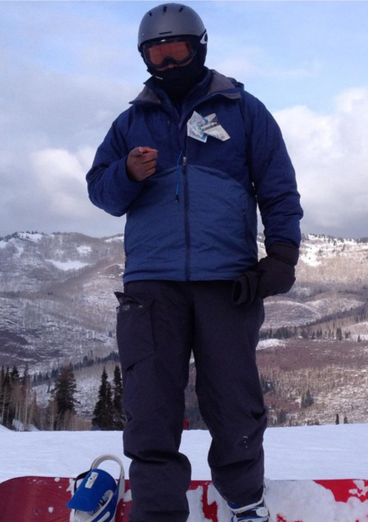 Brian C. Barker poses in front of a snowy mountain.
