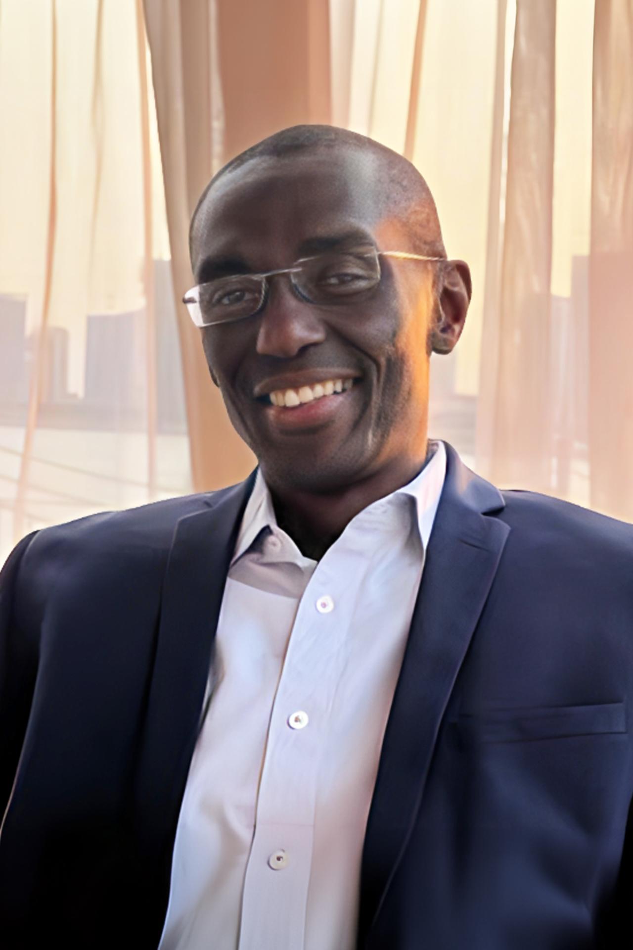 Headshot of Gerard Akindes in a suit