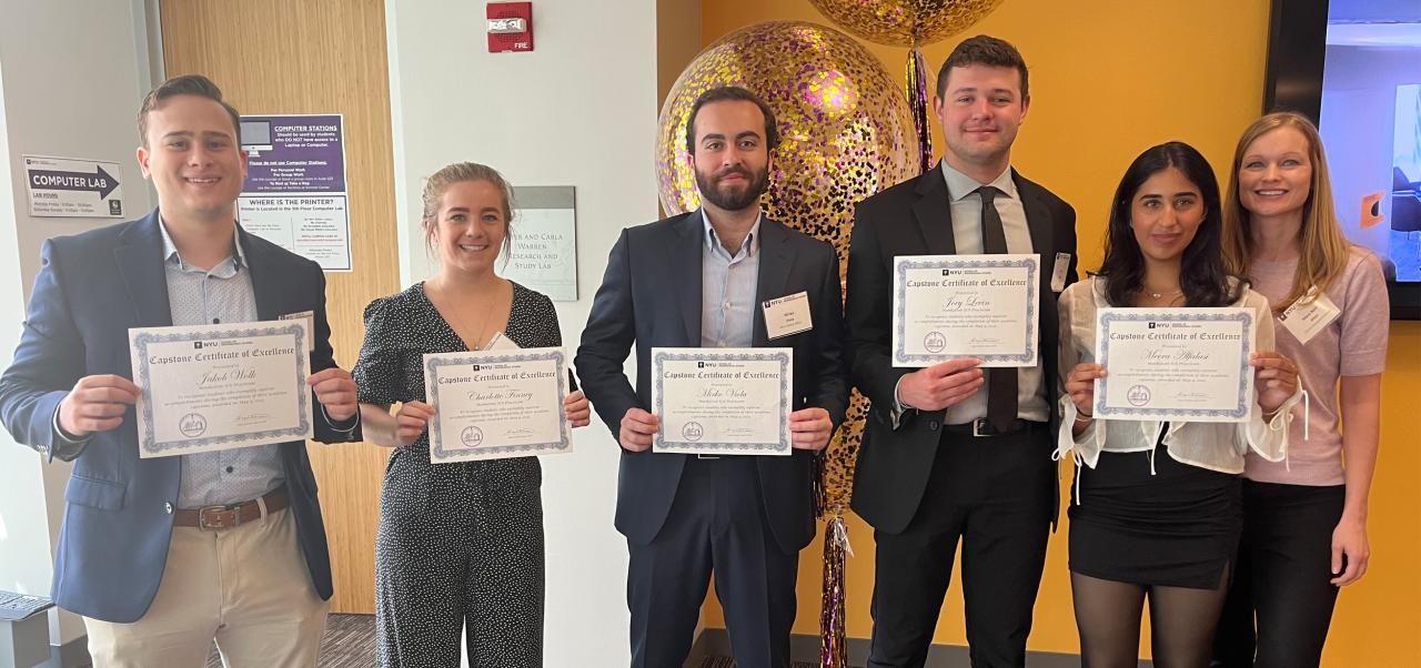 Mary Beth Altier stands to the right of five students holding certificates at the CASE Competition