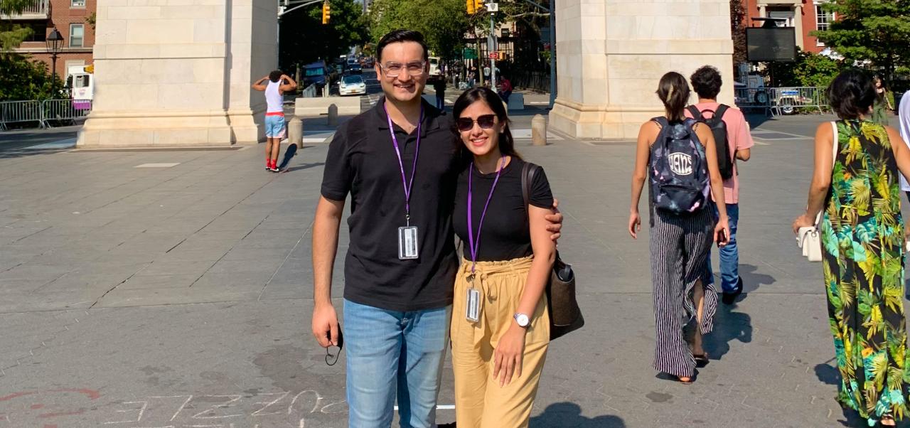 NYU SPS student Chaithanya Bhathi poses for a photo in front of an arch with her husband in Washington Square Park