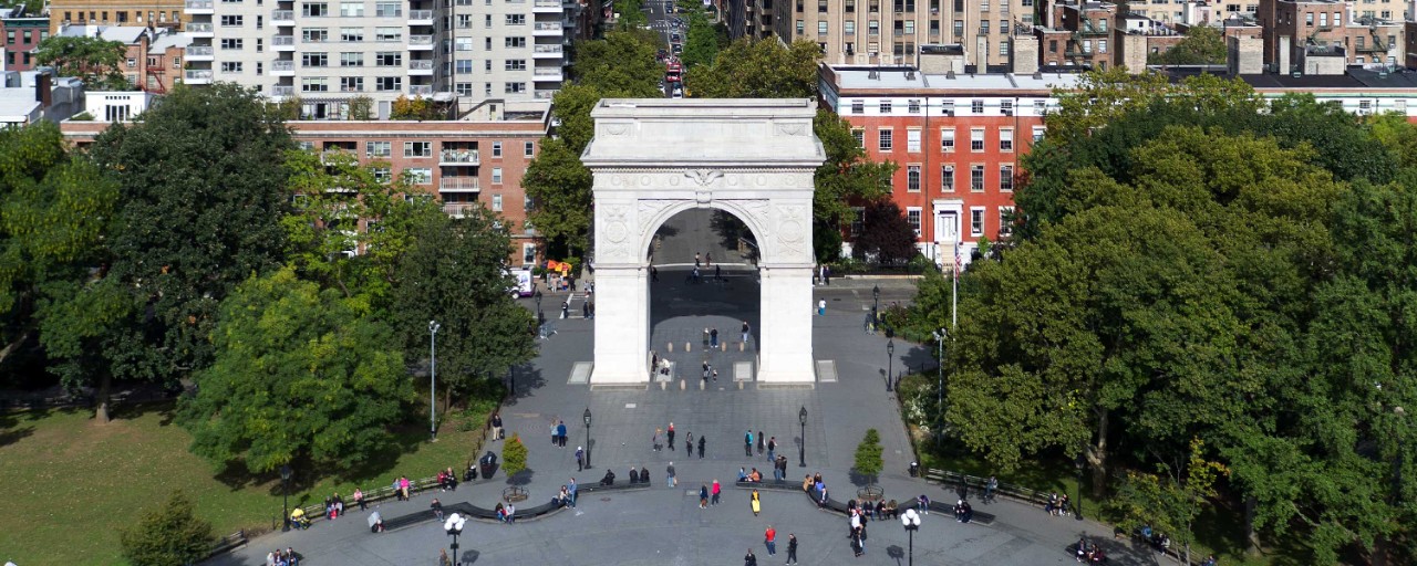 People enjoy a summer day in Washington Square Park in New York City.