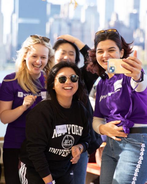 Group of students take a selfie outdoors.