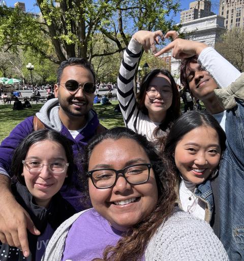 Students hang out outside in a group.