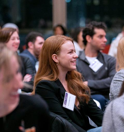 NYU SPS publishing student and scholarship recipient smiles in a crowd at a university event