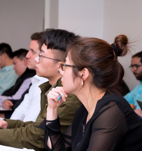 NYU SPS Schack scholarship students take notes during a lecture
